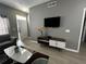 Bright living room with grey walls, wood-look floors, and modern furniture at 4000 Santa Maria Dr # 105, Kissimmee, FL 34741