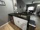 Kitchen island with granite countertop, sink, and dishwasher at 4000 Santa Maria Dr # 105, Kissimmee, FL 34741