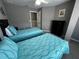 Two twin beds with teal bedding and access to a closet at 4000 Santa Maria Dr # 105, Kissimmee, FL 34741