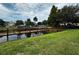 Community lake access with a wooden boardwalk and lush landscaping at 4000 Santa Maria Dr # 105, Kissimmee, FL 34741