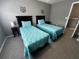 Two twin beds with teal bedding and a dresser at 4000 Santa Maria Dr # 105, Kissimmee, FL 34741