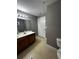 Bathroom with vanity, toilet and access to another room at 4000 Santa Maria Dr # 105, Kissimmee, FL 34741