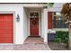 Red front door with brick walkway at 5431 Solterra Cir, Davenport, FL 33837