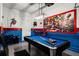 Game room with pool table, foosball, and Marvel-themed decor at 5431 Solterra Cir, Davenport, FL 33837