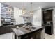 Island kitchen with granite countertops, stainless steel appliances, and breakfast bar at 5431 Solterra Cir, Davenport, FL 33837