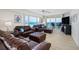 Spacious living room with brown leather furniture and ocean view at 4631 S Atlantic Ave # 8301, Ponce Inlet, FL 32127
