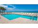 Inviting beachfront pool with ample lounge chairs for relaxation at 4631 S Atlantic Ave # 8301, Ponce Inlet, FL 32127
