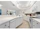 Bright white kitchen with stainless steel appliances and tile backsplash at 4631 S Atlantic Ave # 8301, Ponce Inlet, FL 32127
