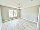 Bright bedroom with large window and wood-look floors at 6425 Sw 180Th Cir, Dunnellon, FL 34432