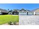 Beautiful two-story home with a three-car garage and well-manicured lawn at 6425 Sw 180Th Cir, Dunnellon, FL 34432
