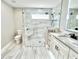 Modern bathroom with walk-in shower, granite countertop, and tile floors at 6425 Sw 180Th Cir, Dunnellon, FL 34432
