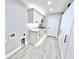 Laundry room with white cabinets, granite countertop, and barn door at 6425 Sw 180Th Cir, Dunnellon, FL 34432