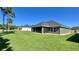 House exterior showcasing a screened patio and green lawn at 6425 Sw 180Th Cir, Dunnellon, FL 34432