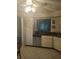 White kitchen cabinets, stainless steel appliances, and view into living room at 2909 Clubview # 2909, Orlando, FL 32822