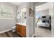 Clean bathroom with wood cabinets and a view into bedroom at 8105 Coconut Palm Way # 203, Kissimmee, FL 34747