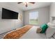 King bedroom with TV, view, and relaxing decor at 8105 Coconut Palm Way # 203, Kissimmee, FL 34747