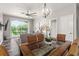 Dining area with glass-top table and wicker chairs overlooking the living room at 8105 Coconut Palm Way # 203, Kissimmee, FL 34747