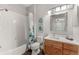 Clean bathroom with tub, shower, and wood vanity at 8105 Coconut Palm Way # 203, Kissimmee, FL 34747