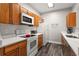 Modern kitchen with white countertops and oak wood cabinets at 8105 Coconut Palm Way # 203, Kissimmee, FL 34747