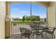 Private balcony with table and chairs, overlooking green space at 8105 Coconut Palm Way # 203, Kissimmee, FL 34747