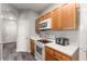 Kitchen with wood cabinets, white appliances, and quartz countertops at 8105 Coconut Palm Way # 203, Kissimmee, FL 34747