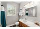 Small bathroom with wood cabinets and a teal shower curtain at 8105 Coconut Palm Way # 203, Kissimmee, FL 34747