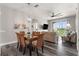 Bright dining room with glass-top table and wicker chairs, open to the living room at 8105 Coconut Palm Way # 203, Kissimmee, FL 34747