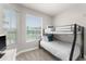 Bright bedroom with a bunk bed and large window offering natural light at 8105 Coconut Palm Way # 203, Kissimmee, FL 34747