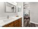Bathroom with wood cabinets and a view into living room at 8105 Coconut Palm Way # 203, Kissimmee, FL 34747