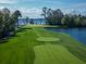 Aerial view of a beautiful golf course hole next to a lake at 10138 Chiltern Garden Dr, Orlando, FL 32827