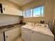 Convenient laundry room with washer, dryer, and storage cabinets at 3219 Brasilia Ave, Kissimmee, FL 34747