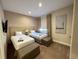 Guest bedroom with twin beds and plenty of natural light at 3219 Brasilia Ave, Kissimmee, FL 34747
