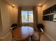 Bright dining area with wooden table and four chairs, overlooking courtyard at 3219 Brasilia Ave, Kissimmee, FL 34747