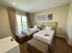 Two twin beds, balcony access, and neutral decor at 3219 Brasilia Ave, Kissimmee, FL 34747