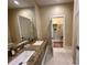 Double vanity with granite countertop and large mirror at 3219 Brasilia Ave, Kissimmee, FL 34747