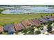 Houses with solar panels and a lake in the background at 290 Silver Maple Rd, Groveland, FL 34736