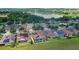 Houses with solar panels and a lake view in a residential community at 290 Silver Maple Rd, Groveland, FL 34736