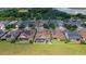 Aerial view of a community with houses featuring solar panels and a pool at 290 Silver Maple Rd, Groveland, FL 34736