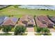 Aerial view of home with solar panels and lake view at 290 Silver Maple Rd, Groveland, FL 34736
