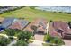 Aerial view of home with solar panels and lake view at 290 Silver Maple Rd, Groveland, FL 34736