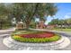 Gated entrance to Trilogy with lush landscaping and brick columns at 290 Silver Maple Rd, Groveland, FL 34736