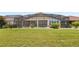 Spacious backyard showcasing a large screened-in pool area at 290 Silver Maple Rd, Groveland, FL 34736