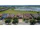 Aerial view of home with solar panels and lake view at 290 Silver Maple Rd, Groveland, FL 34736