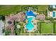 Community pool with a shade structure and surrounding landscaping at 290 Silver Maple Rd, Groveland, FL 34736