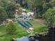 Many kayaks and canoes are neatly stored on racks near the water at 411 Palo Verde Dr, Leesburg, FL 34748