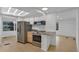 Modern kitchen featuring stainless steel appliances and granite countertops at 411 Palo Verde Dr, Leesburg, FL 34748