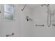 Clean bathroom with shower, grab bars, and storage at 411 Palo Verde Dr, Leesburg, FL 34748