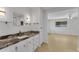 Bathroom with granite countertop and a view into another room at 411 Palo Verde Dr, Leesburg, FL 34748