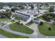 An aerial view of a community center situated near a lake at 411 Palo Verde Dr, Leesburg, FL 34748