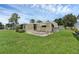 Mobile home with a screened porch and a large grassy backyard at 411 Palo Verde Dr, Leesburg, FL 34748